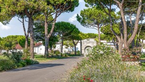 Un sendero que lleva a un edificio con un arco de piedra y una placa que reza 'Batteria C. Carabba'.
