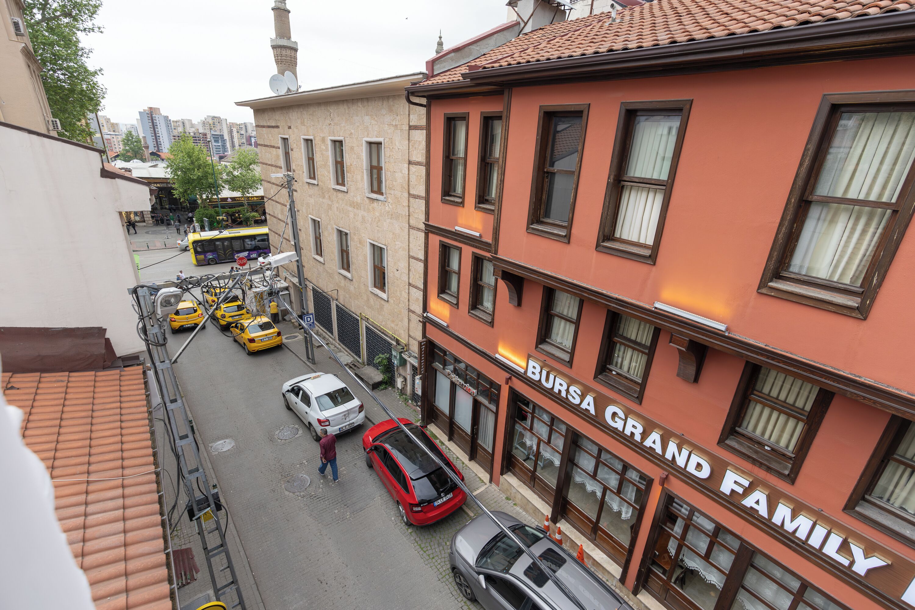 A street view with a building labeled "BURSA GRAND FAMILY".