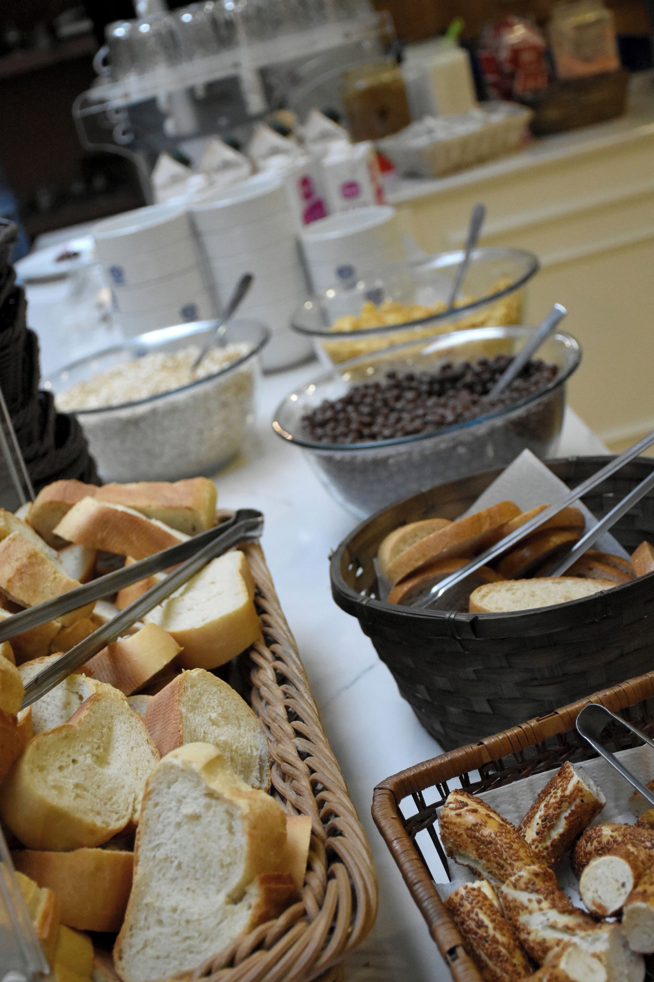 A buffet table with various food items including bread, chocolate chips, and other snacks.