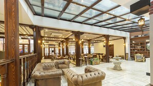 A spacious lobby with a high ceiling, a glass roof, and a seating area with plush sofas. - Bursa Grand Family Hotel & Spa (Bursa)