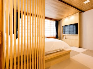 A room with a bed, a window, and a television. - Nara Ryokan (Nara)