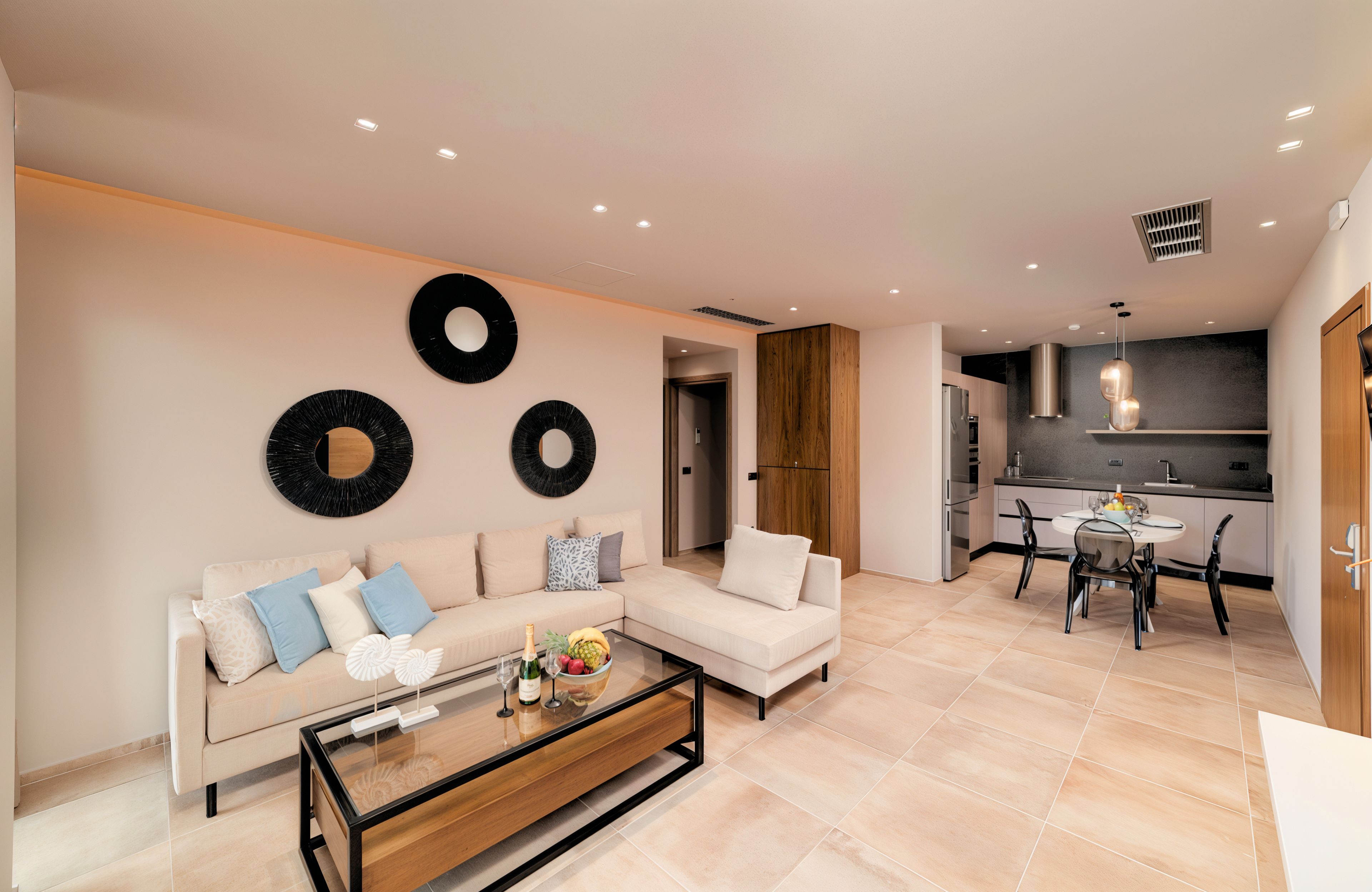 A modern living room with a sofa, coffee table, and wall art.
