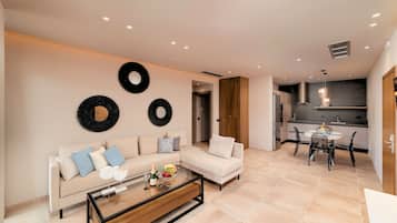 A modern living room with a sofa, coffee table, and wall art.