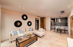 A modern living room with a sofa, coffee table, and wall art.