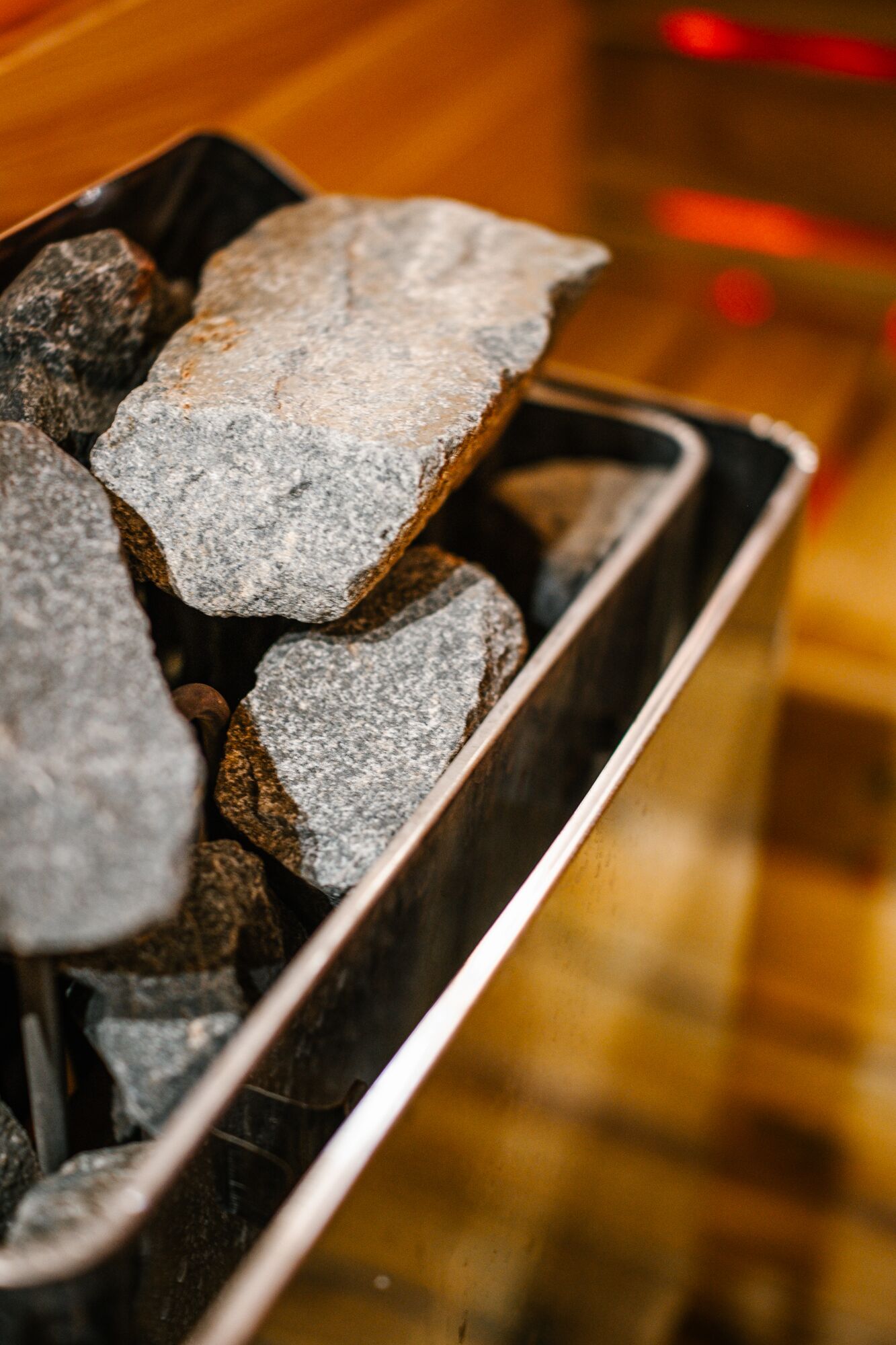 A metal container filled with charcoal briquettes.