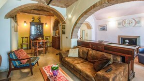 A cozy living room with a leather sofa, a dining area with a wooden cabinet, and a billiards table. - Pet friendly home in Mazzolla (Mazzolla)