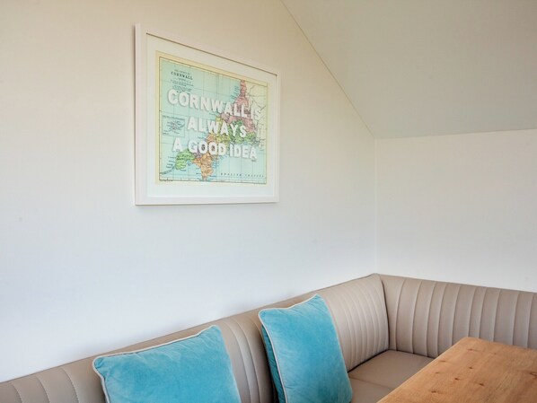 A framed map of Cornwall with the text "Cornwall is always a good idea" on a white wall.