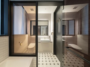 A modern bathroom with a glass partition, a toilet, a sink, and a mirror. - GINZA HOTEL by GRANBELL (Tokyo)