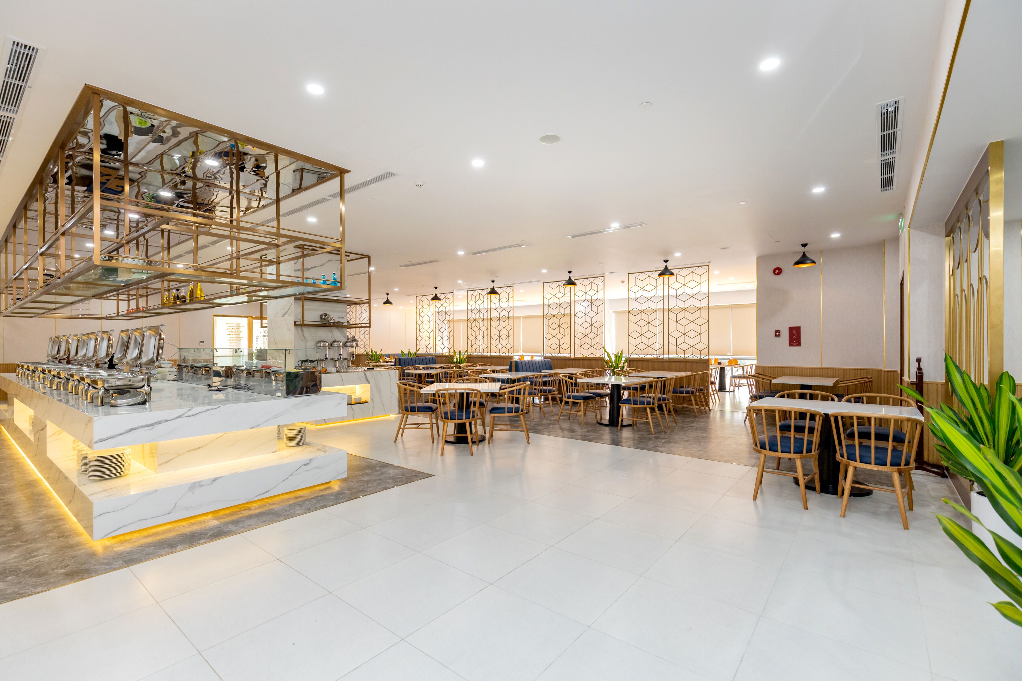 A spacious restaurant with a high ceiling, a central bar area, and multiple seating options including tables and booths.