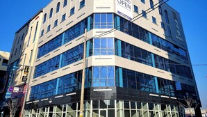 A multi-story hotel with a modern facade, large windows, and a prominent 'Grand Open' sign. - Hi&Hotel (Pyeongtaek)