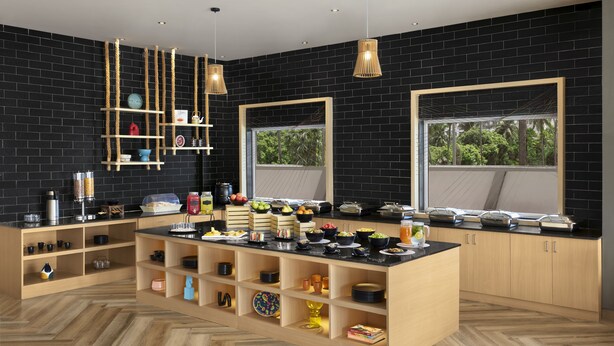 Una cocina moderna con paredes de ladrillo negro, armarios de madera y una isla central con diversos alimentos y utensilios.