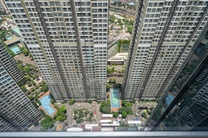 A high-rise residential building with a central courtyard, multiple balconies, and a swimming pool. - Landmark 81 - Unique Condotel (Ho Chi Minh City)