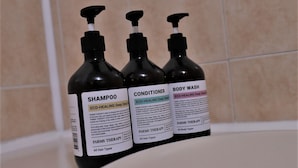Three bottles of Farms Therapy products on a bathroom counter. - Hotel Hany (Daejeon)