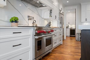 Enjoy cooking in this well-equipped kitchen with an oven, microwave, and stainless steel range hood.