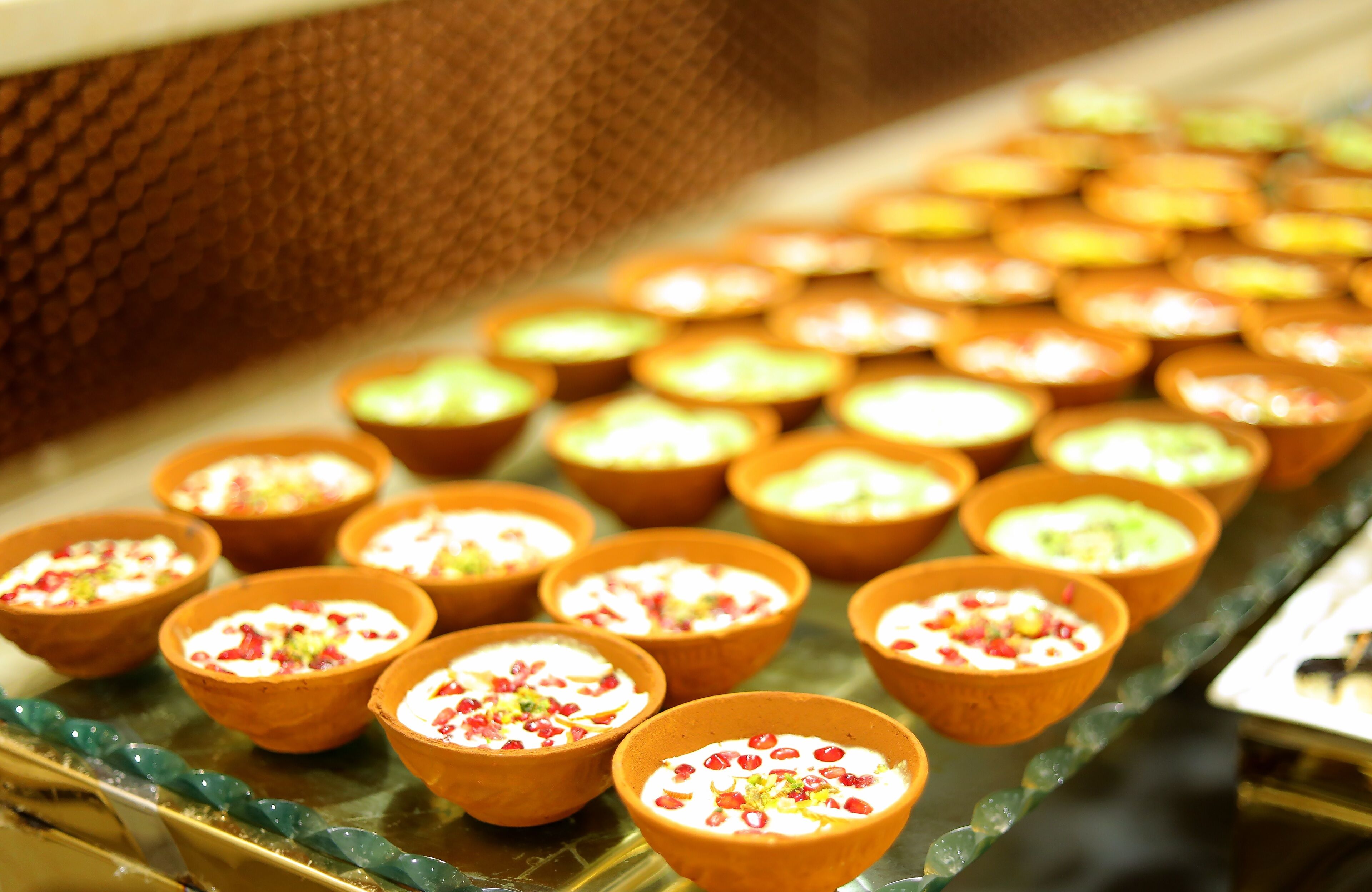 A display of various dessert bowls arranged on a tray.