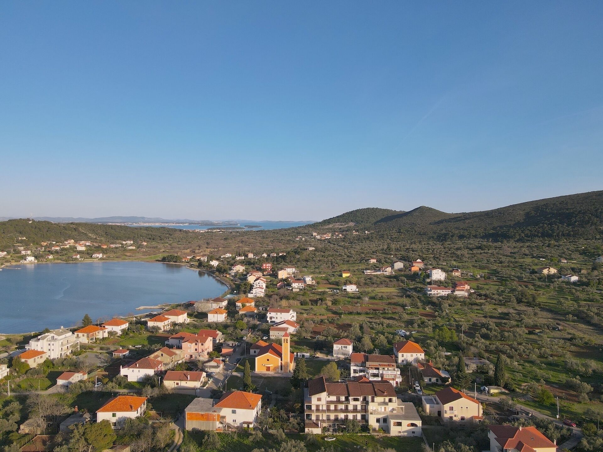 A coastal town with buildings and a lake.