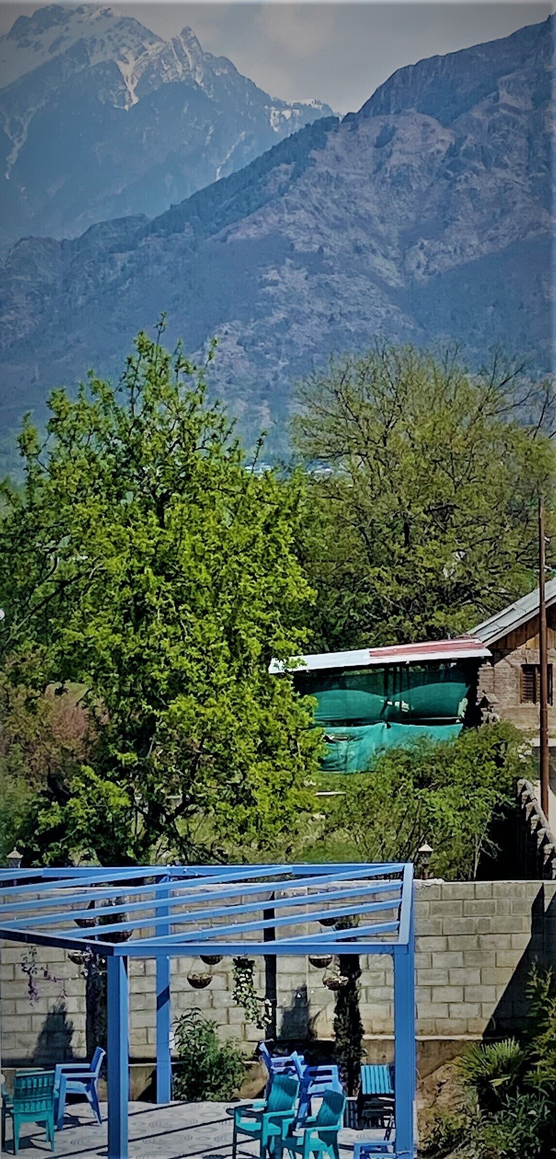 A mountain view with a pergola and outdoor seating area.