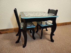 Enjoy meals in style at this dining table with two matching chairs.
