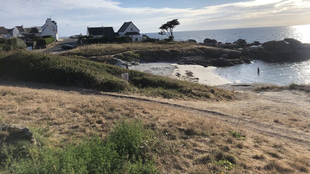 A coastal landscape with houses, a beach, and a rocky shoreline. - Recently refurbished villa with sea views, closed garden and 80 m from beach. (Tregunc)