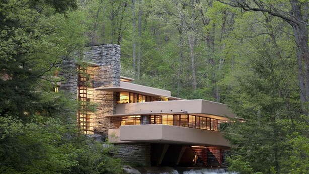 A modern building with a waterfall in front.
