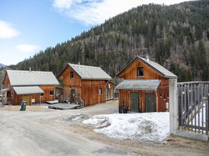 Escape to a secluded cabin nestled among the trees, surrounded by a dense forest.