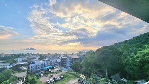 A coastal cityscape with buildings, a parking area, and a view of the sea and distant islands. - Bo501 - 2 Bdr Condo With Sea View, Ao Nang Beach (Krabi)