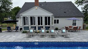 A house with a swimming pool, outdoor seating, and a covered patio area. - Lenox Grand Colonial with Pool by Evergreen Home (Lenox)