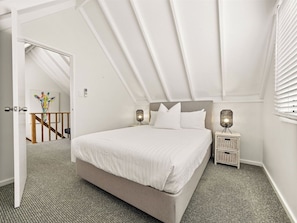 The second bedroom offers a comfortable queen bed beneath charming pitched ceilings, creating a peaceful space to recharge after coastal adventures. - Pepper Cottage—Easy Beachside Living Close to Town (Dunsborough)