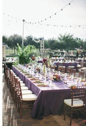 Enjoy a meal in our garden patio, surrounded by string lights and comfortable seating.