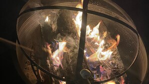 A fire feature with a metal mesh enclosure. - Lakeside Camping RV Spot #10 Near Death Valley (Olancha)