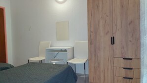 A bedroom with a bed, a desk, two chairs, and a wardrobe. - Nar Apartment A4 - With sea View Terrace (Pasman)