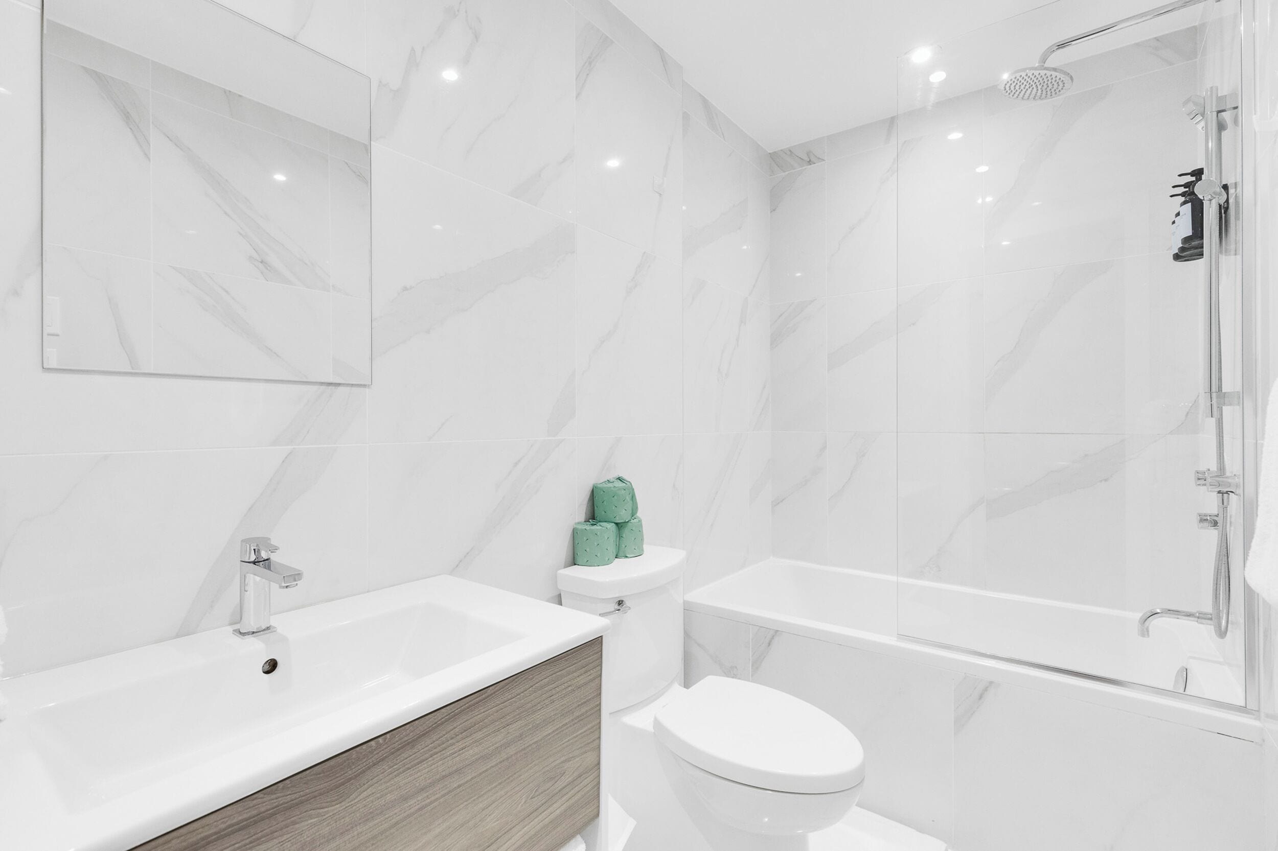 A modern bathroom with a bathtub, toilet, and sink.