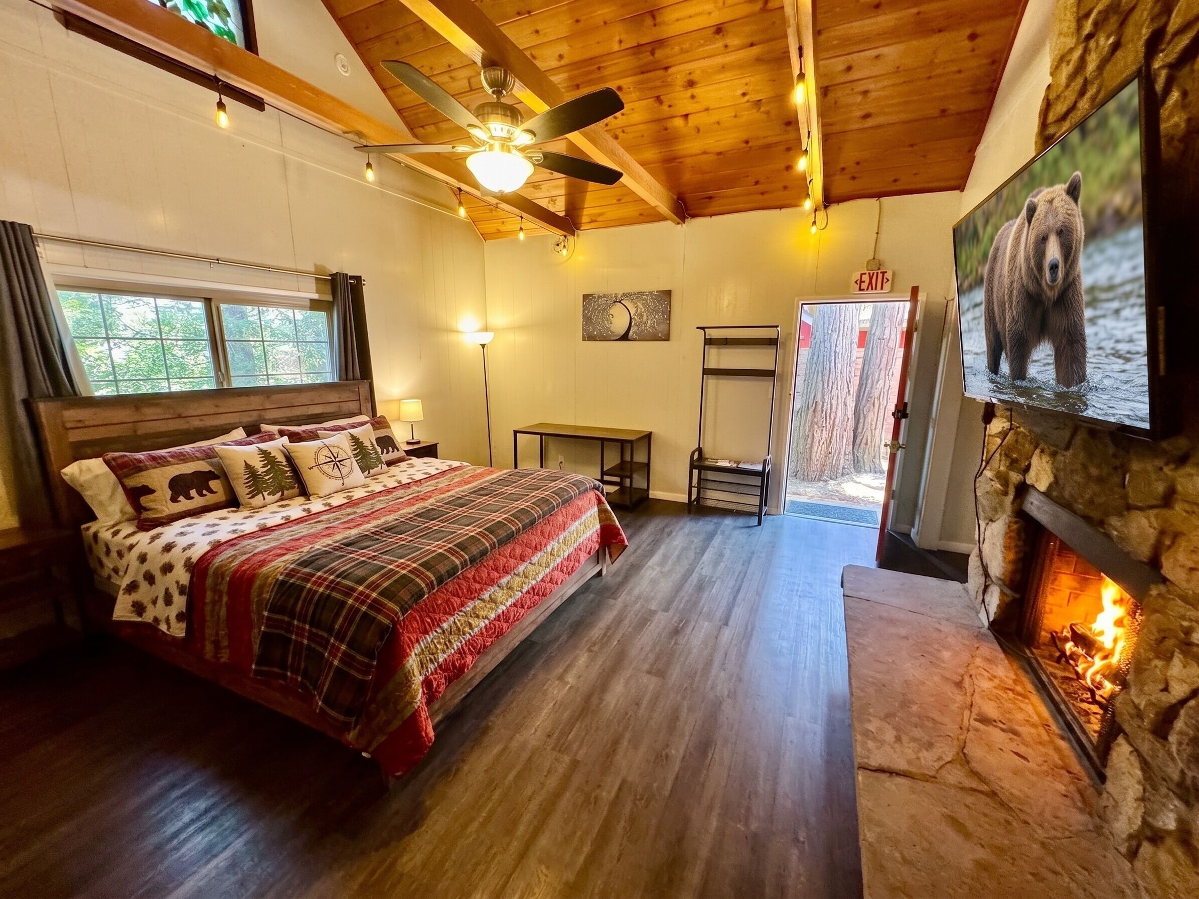 Un dormitorio acogedor con cama, chimenea y ventilador de techo.