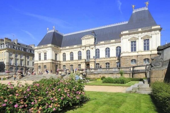 A historic building with a central courtyard, large windows, and a prominent entrance.