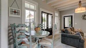 A dining area with a round table, chairs, and a sofa. - Summer Kitchen Cottage/Lake Carolina/Colombia,S.C./Harborside Community (Columbia)