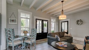 A spacious living room with a round table, two sofas, and a chandelier. - Summer Kitchen Cottage/Lake Carolina/Colombia,S.C./Harborside Community (Columbia)