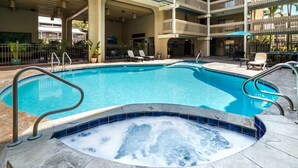 A swimming pool with a hot tub, surrounded by lounge chairs and a covered seating area. - 🏖️Direct Ocean Front | Close to Town | AC | Upper Floor (Kailua Kona)