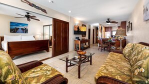 A spacious living room with a sofa set, a coffee table, and a dining area with chairs and a table. - 🏖️Direct Ocean Front | Close to Town | AC | Upper Floor (Kailua Kona)