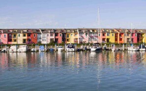 Stunning waterfront setting with colorful buildings and boats docked along the marina.