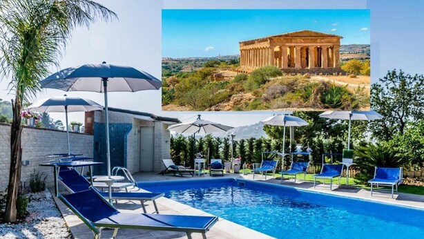 A swimming pool with lounge chairs and umbrellas, surrounded by greenery and a stone wall. - Room in B&B - Relais Dea Degli Ulivi House (Agrigento)