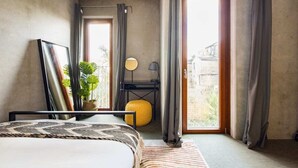 A bedroom with a bed, a bedside table, a mirror, a potted plant, and a window with curtains. - The Victoria Park Sanctuary - Stunning 2bdr Flat (London)