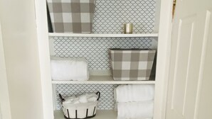 A white storage closet with a mesh door, shelves, and a brown floor. - Country paradise! Close to Telluride (Norwood)