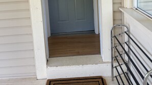 A front door with a 'WELCOME' mat, a small porch with a metal railing, and a window with blinds. - Country paradise! Close to Telluride (Norwood)