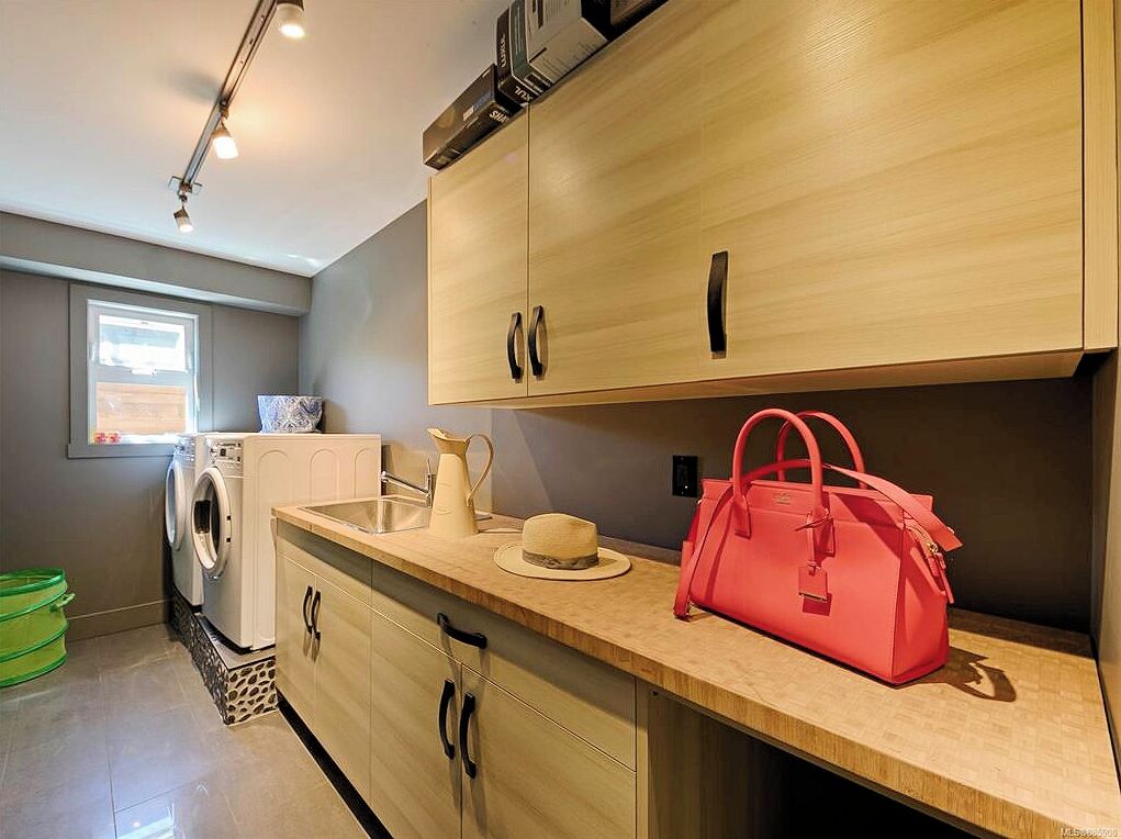 A modern kitchen with wooden cabinets, a sink, and a countertop.