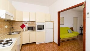 A compact kitchen with a stove, microwave, and refrigerator. - Holiday Home Blue Vineyard- Three Bedroom House With Terrace and Sea View (Orebic)