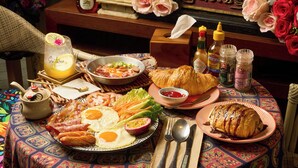 A breakfast table with various dishes, a teapot, condiments, and a decorative setting. - Pran at Kumuang Boutique House (Chiang Mai)