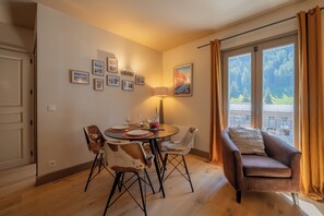 A dining area with a round table, chairs, and a sofa. - V Buet 41: Beside Ski Lift; Pool, Sauna & Gym, Vallorcine (Argentiere), France (Vallorcine (Argentiere))