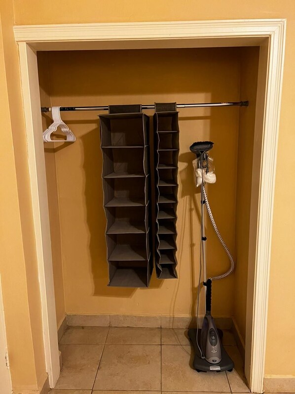 A closet with shelves and a vacuum cleaner. - Meson Del Rey (Nuevo Laredo)
