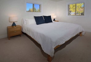 A bedroom with a large bed, two bedside tables, and two windows. - Hidden Gem, Hot tub, Garage, Amazing Views! (Mt. Crested Butte)
