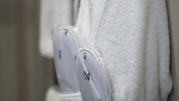 A bathroom with white towels hanging on a rack.